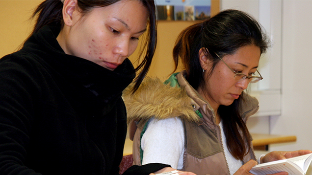 Two Asian-background women studying.